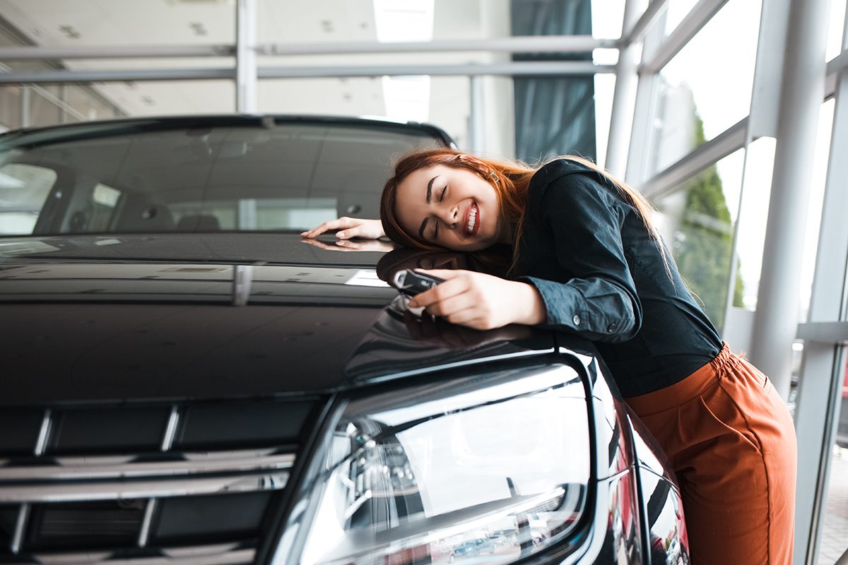 Happy Woman Hugs Her New Car